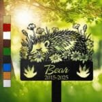 Hedgehog resting in a peaceful sleeping pose within a daisy floral border on a personalized metal garden stake, with clawed footprint cutouts at the base.