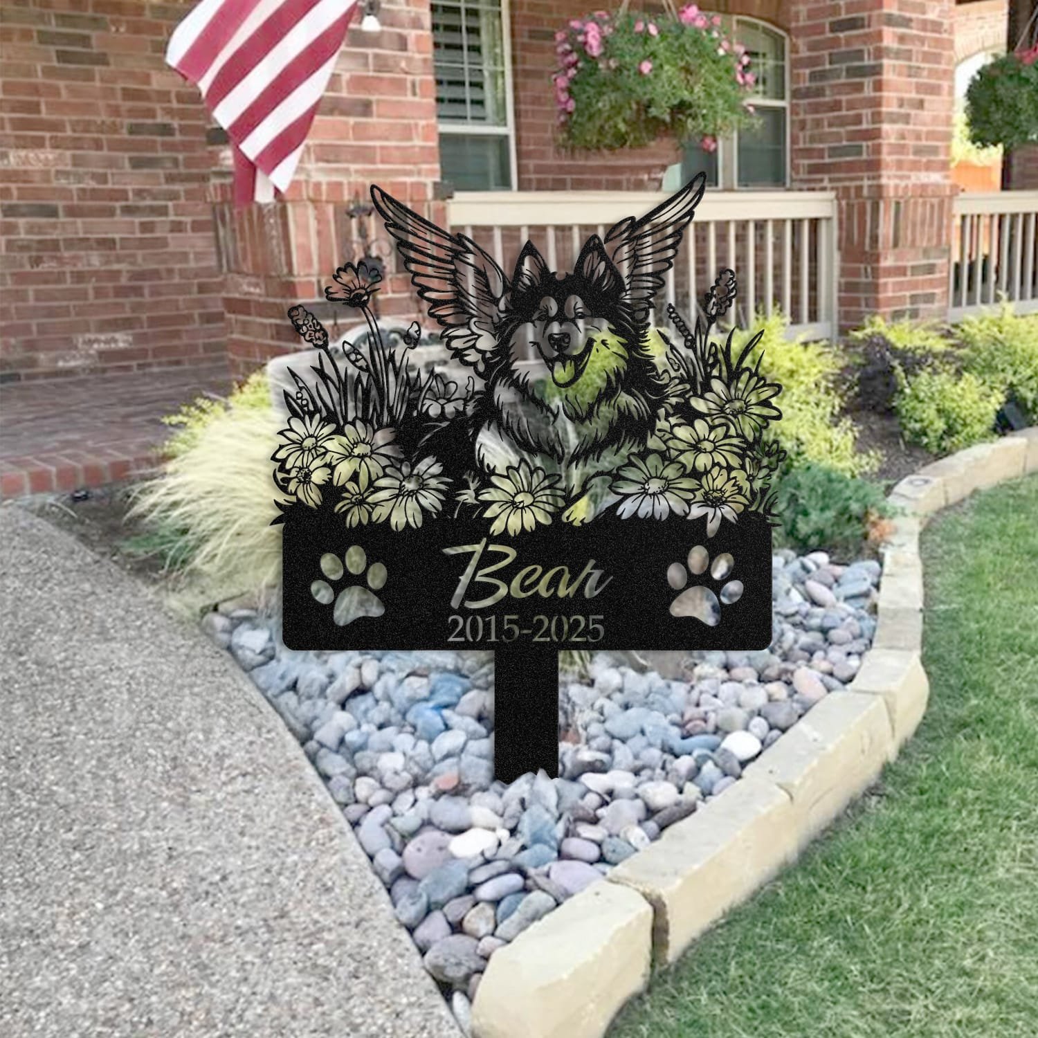 Husky pet grave marker staged near a home entryway, showing the finished angel wings and daisy floral design and name plate outdoors.