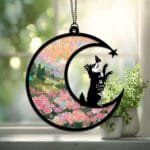 Crescent moon suncatcher with a playful Husky silhouette reaching up toward a butterfly over a stained-glass pink rose garden
