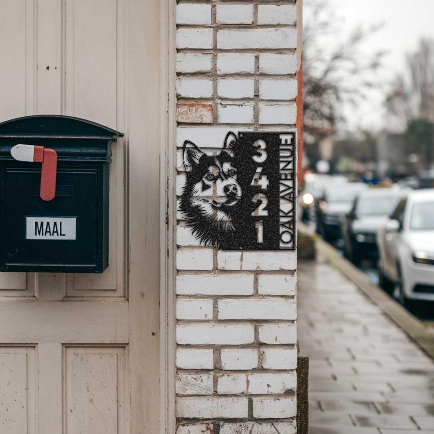 Husky address sign mounted on a brick pillar near a mailbox and front door