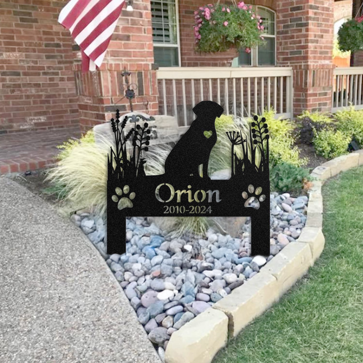Labrador pet grave marker staged near a home entryway, showing the finished heart-cutout silhouette design and name plate outdoors.