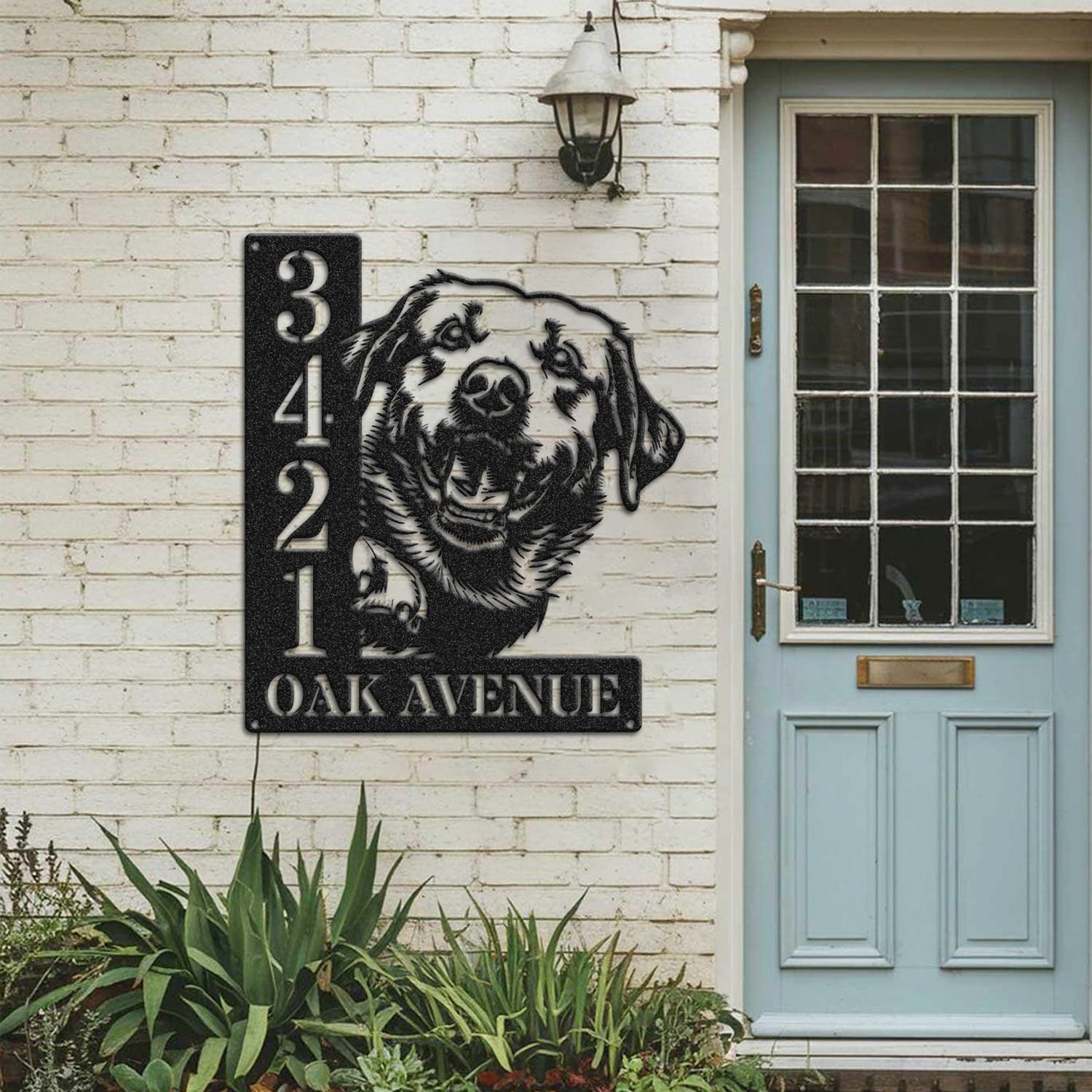 Labrador address sign mounted on a painted brick wall beside a wooden front door