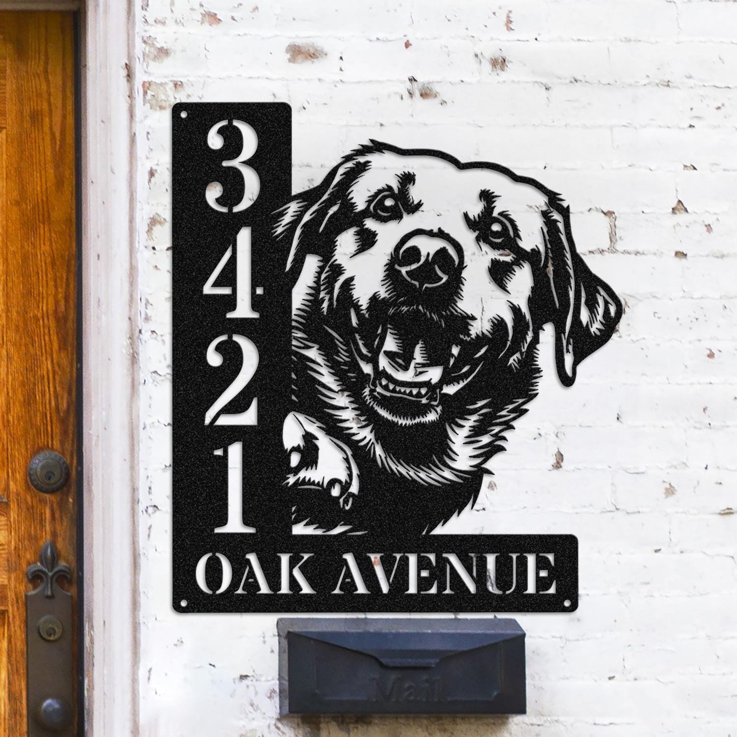 Labrador address sign mounted on a light brick wall in a street-facing view