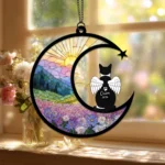 Angel-winged cat silhouette memorial suncatcher glowing in a sunny window, a keepsake for losing a cat