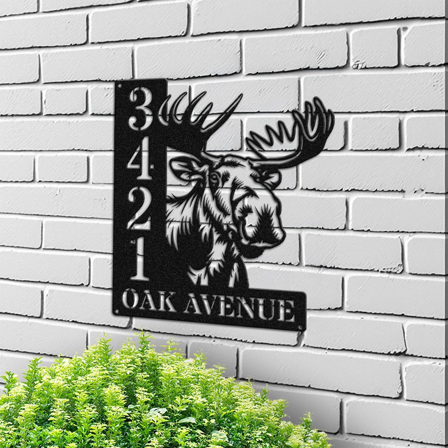Moose address sign mounted on a light brick wall in a street-facing view