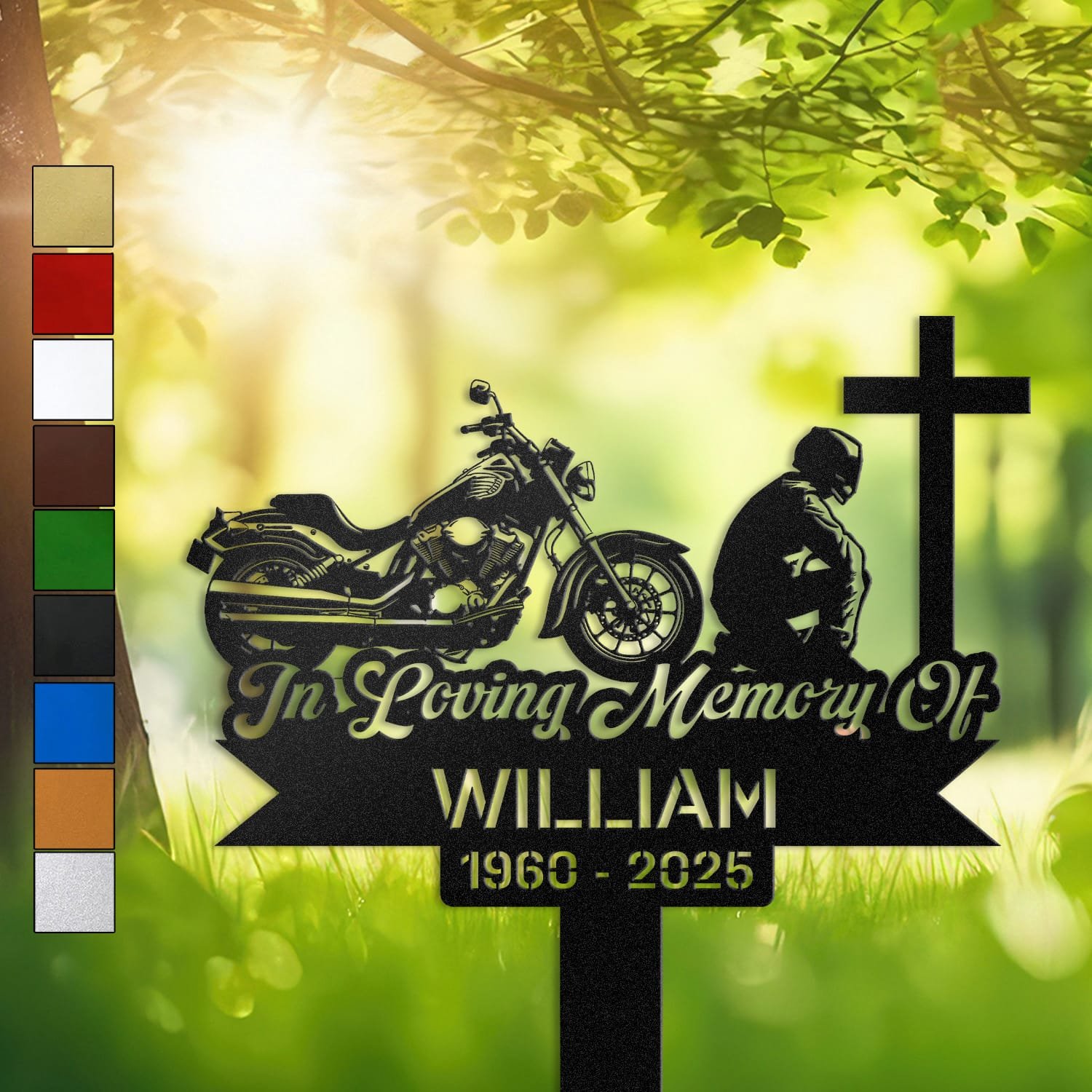 Motorcycle human grave marker displayed outdoors in a garden setting, showing the personalized motorcycle kneeling-at-the-cross design in place on the stake.