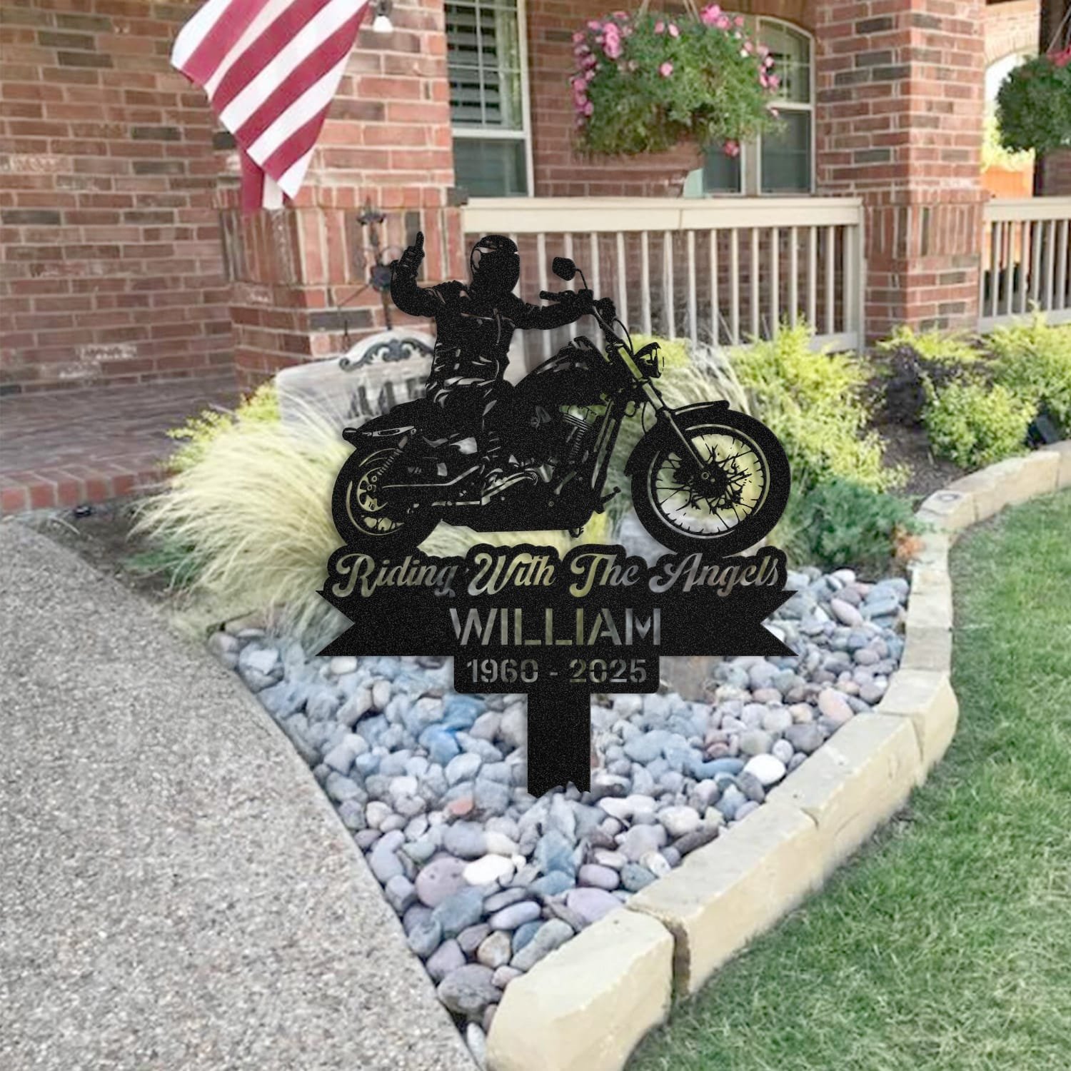 Motorcycle human grave marker staged near a home entryway, showing the finished motorcycle rider silhouette design and name plate outdoors.