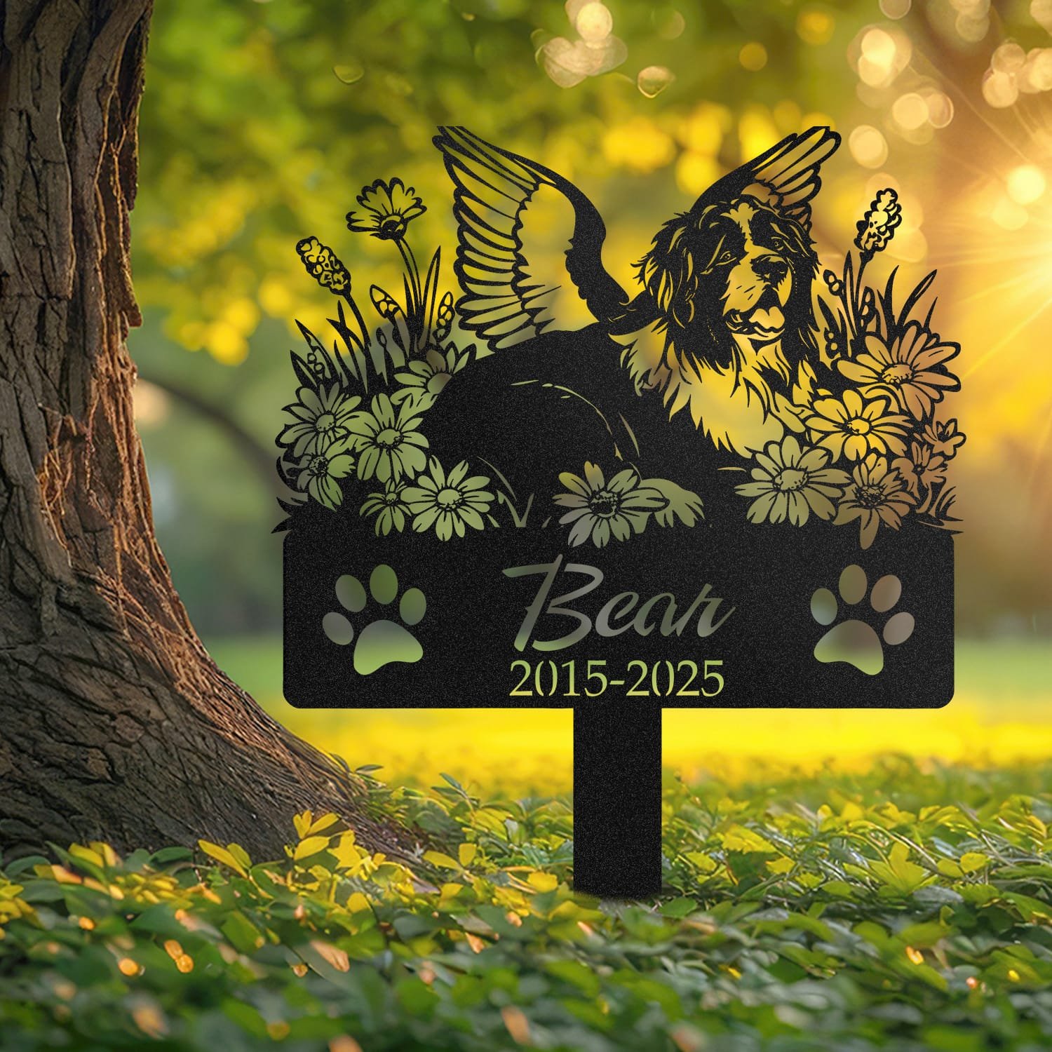 Newfoundland pet grave marker displayed outdoors in a garden setting, showing the personalized angel wings and daisy floral design in place on the stake.
