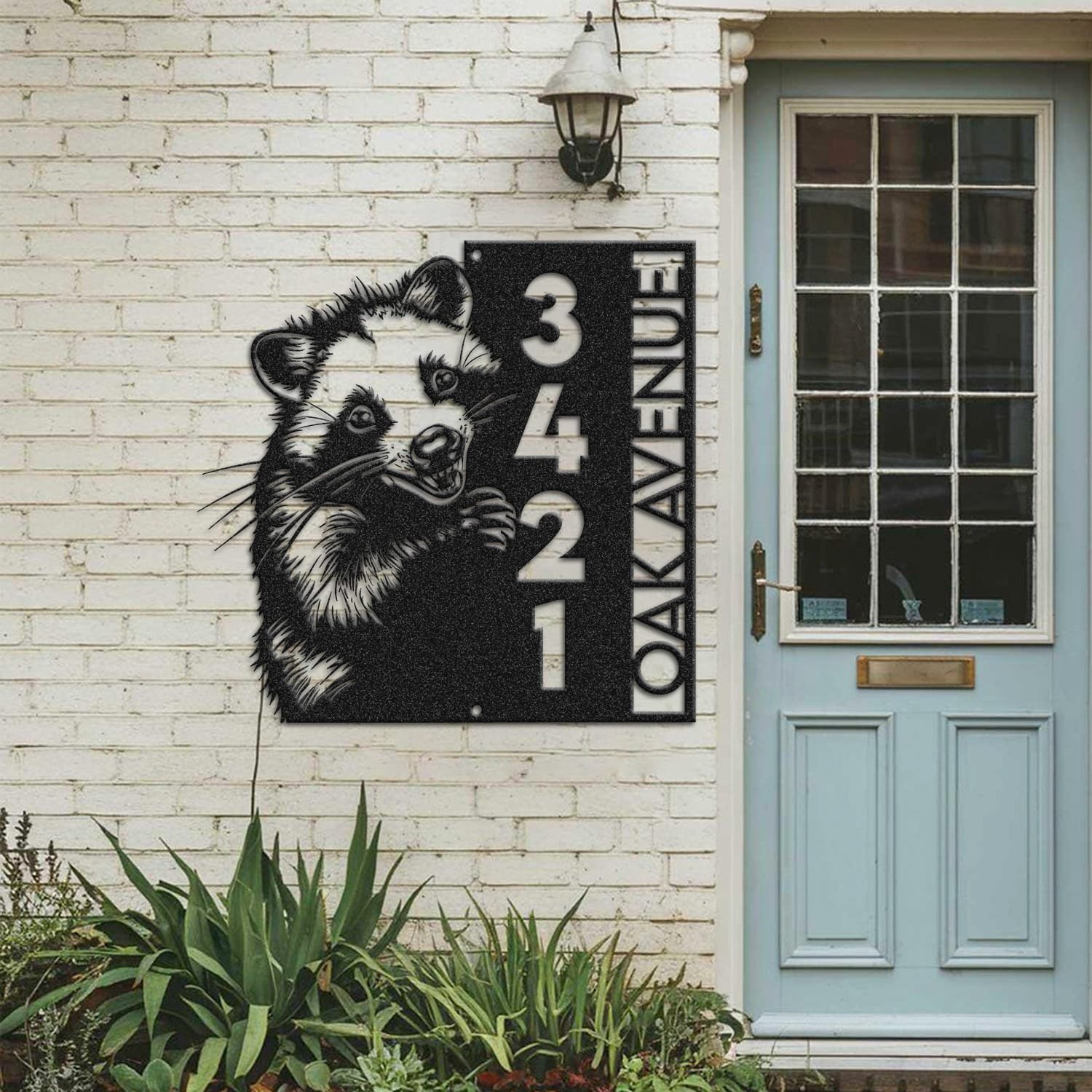 Opossum address sign mounted on a painted brick wall beside a wooden front door