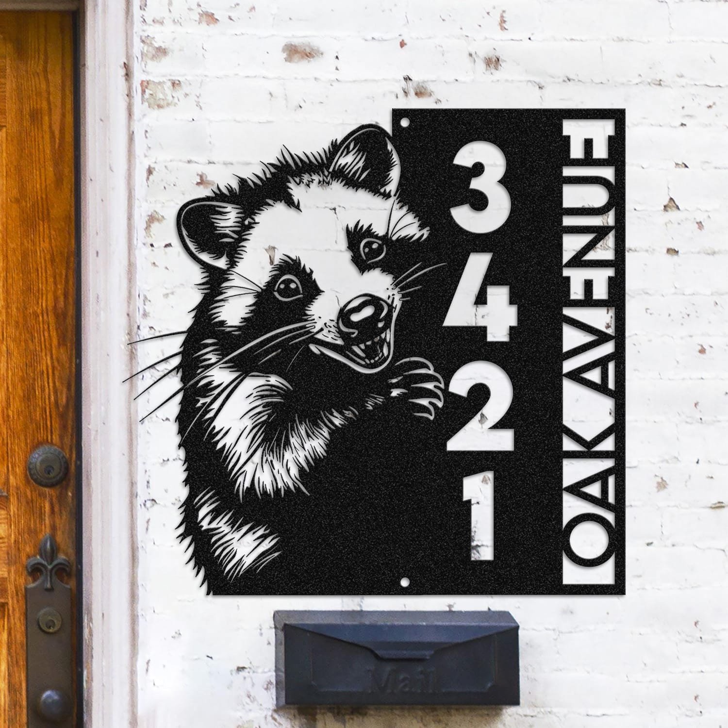 Opossum address sign mounted on a light brick wall in a street-facing view