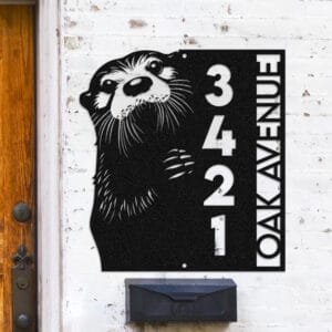 Personalized otter address sign with an otter peeking over a vertical house number plaque reading 3421 Oak Avenue