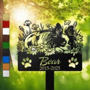 Papillon resting in a peaceful sleeping pose within a daisy floral border on a personalized metal garden stake, with paw print cutouts at the base.