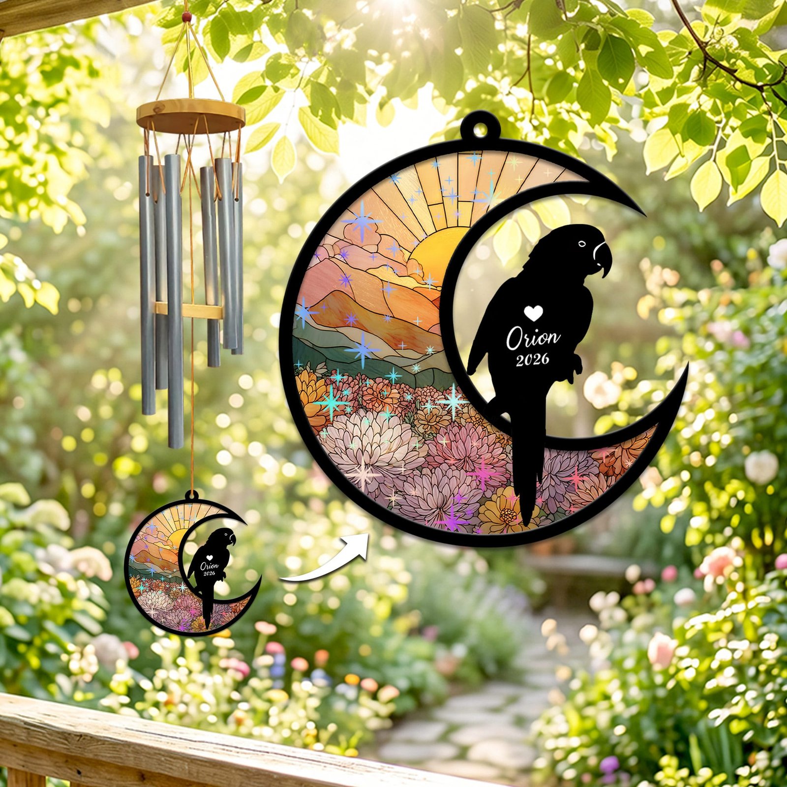 Stained-glass memorial wind chime suncatcher showing a parrot silhouette perched on a crescent moon over pink and cream chrysanthemums at sunrise