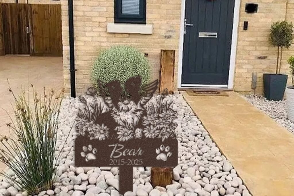 Pet memorial garden marker in a stone garden bed, a peaceful spot to visit while grieving pet loss