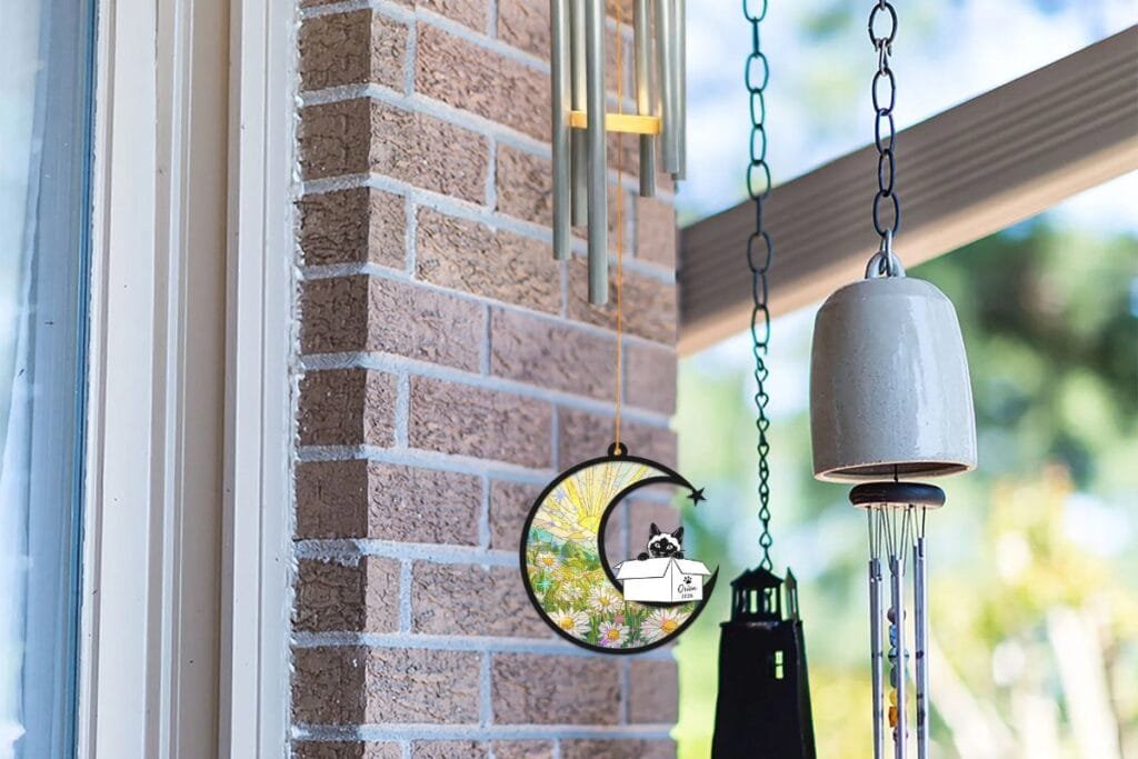 Pet memorial wind chime suncatcher hanging outdoors, a small daily ritual for pet loss grief