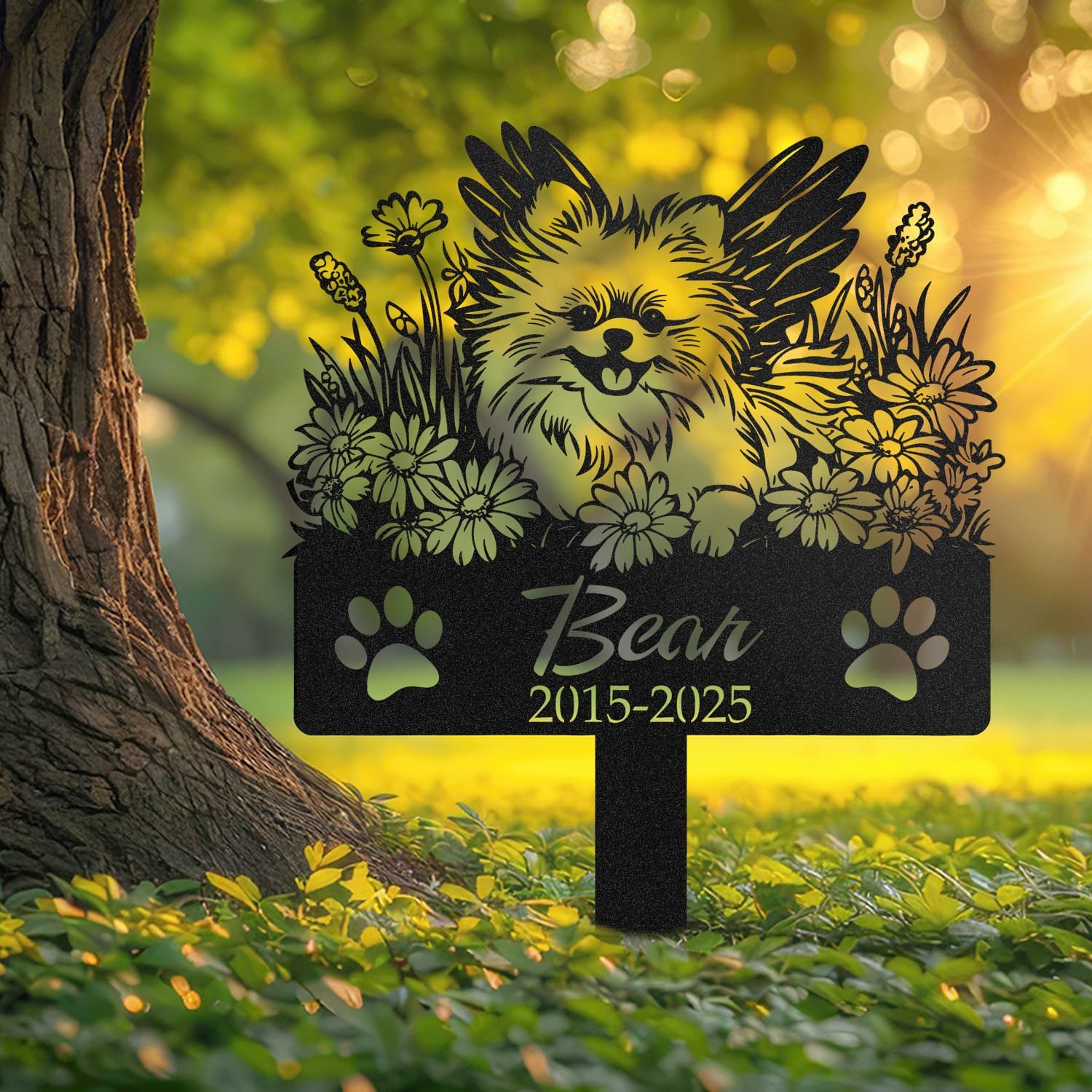 Pomeranian pet grave marker displayed outdoors in a garden setting, showing the personalized angel wings and daisy floral design in place on the stake.