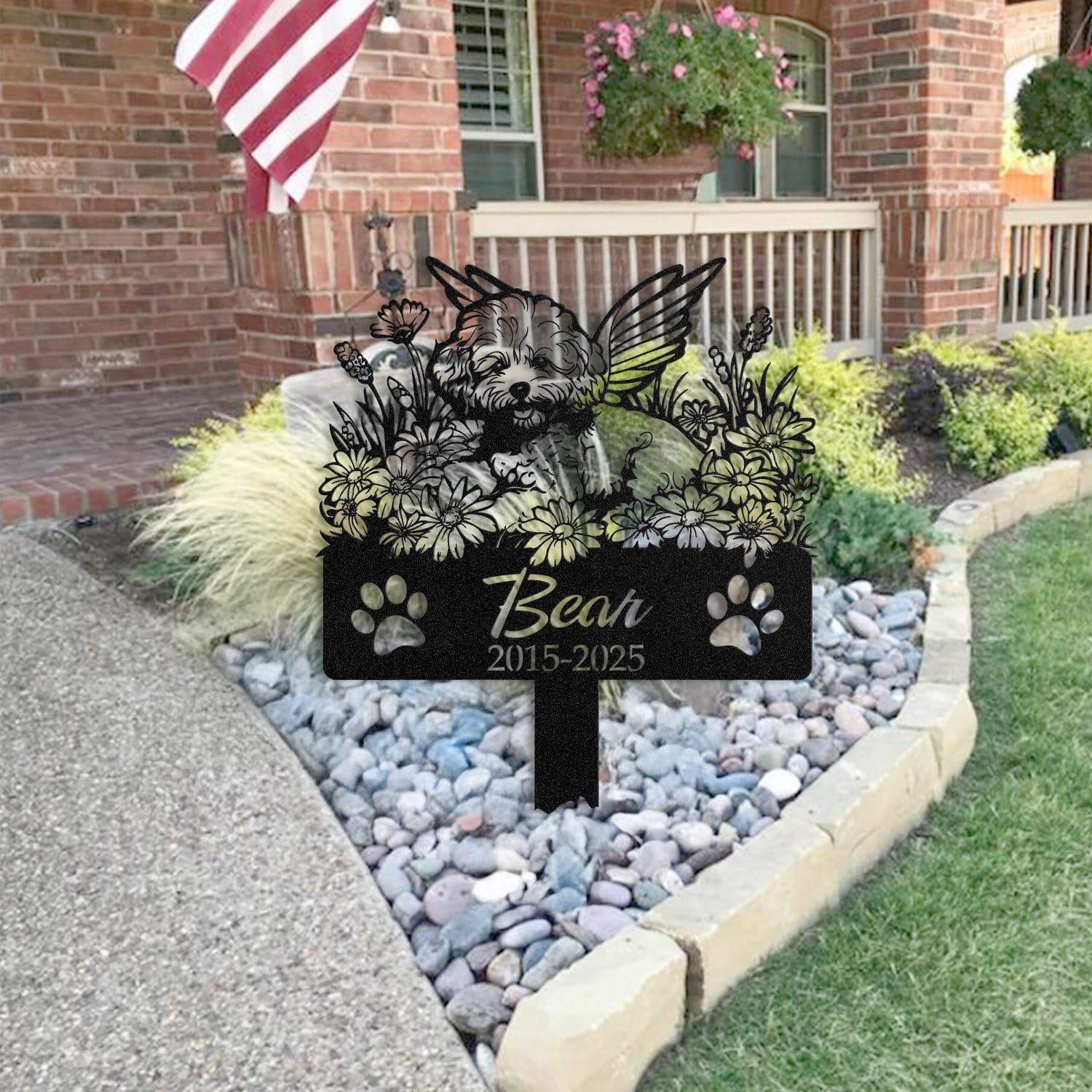 Poodle pet grave marker staged near a home entryway, showing the finished angel wings design with the 'Forever Loved' engraving and name plate outdoors.