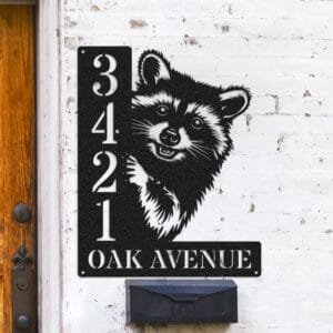 Personalized raccoon address sign with a raccoon's masked face peeking over a vertical house number plaque reading 3421 Oak Avenue
