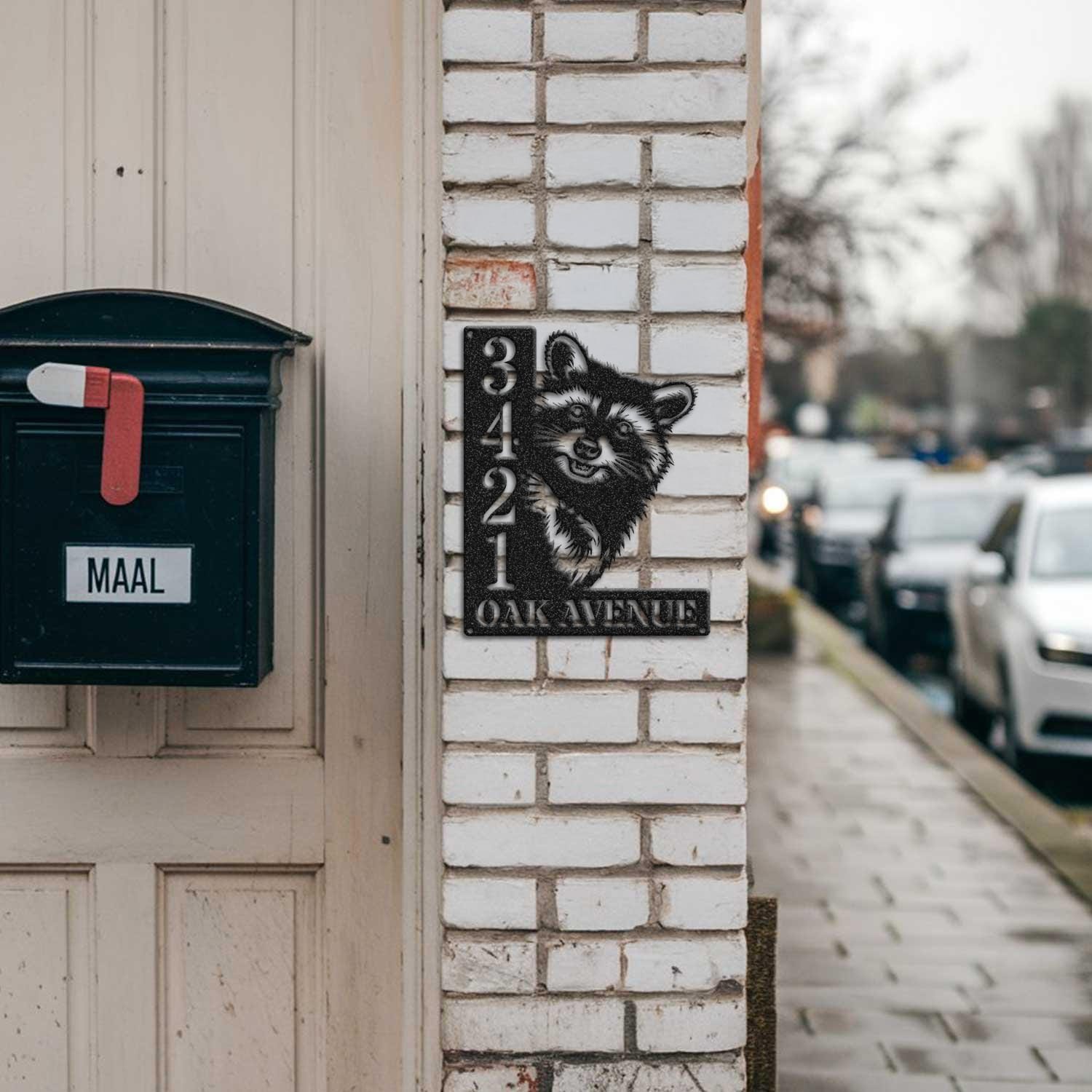 Raccoon address sign mounted on a brick pillar near a mailbox and front door