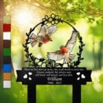 Pair of orange-breasted robins inside a floral wreath on a personalized metal garden stake, engraved with a memorial verse and name plate.