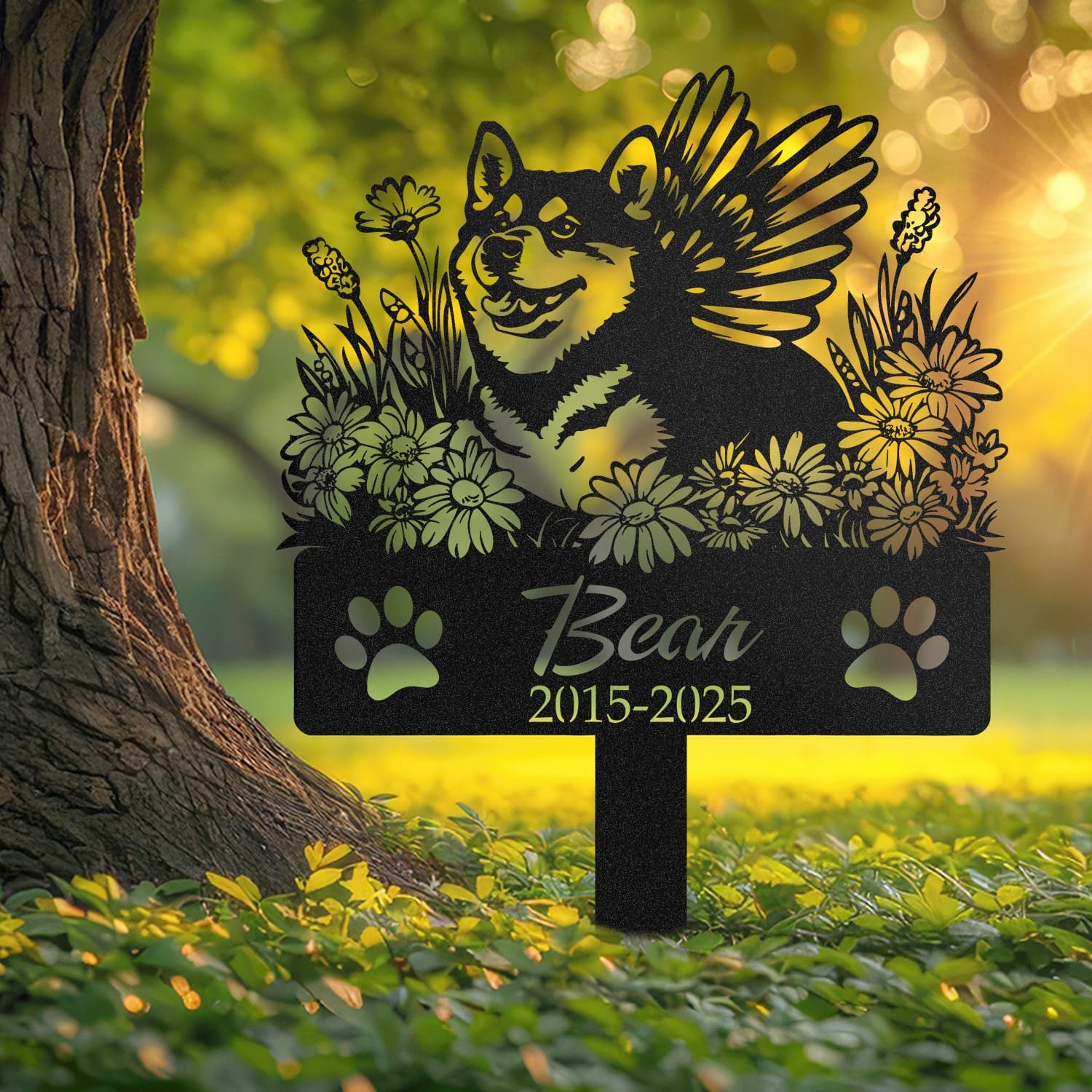 Shiba Inu pet grave marker displayed outdoors in a garden setting, showing the personalized angel wings and daisy floral design in place on the stake.