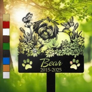Shih Tzu sitting among daisy florals with butterflies fluttering above, on a personalized metal garden stake with paw print cutouts at the base.