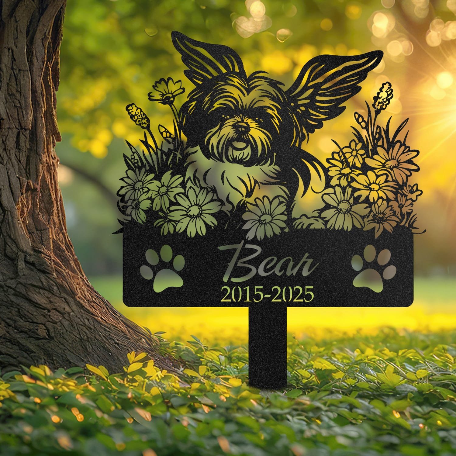 Shih Tzu pet grave marker displayed outdoors in a garden setting, showing the personalized angel wings and daisy floral design in place on the stake.