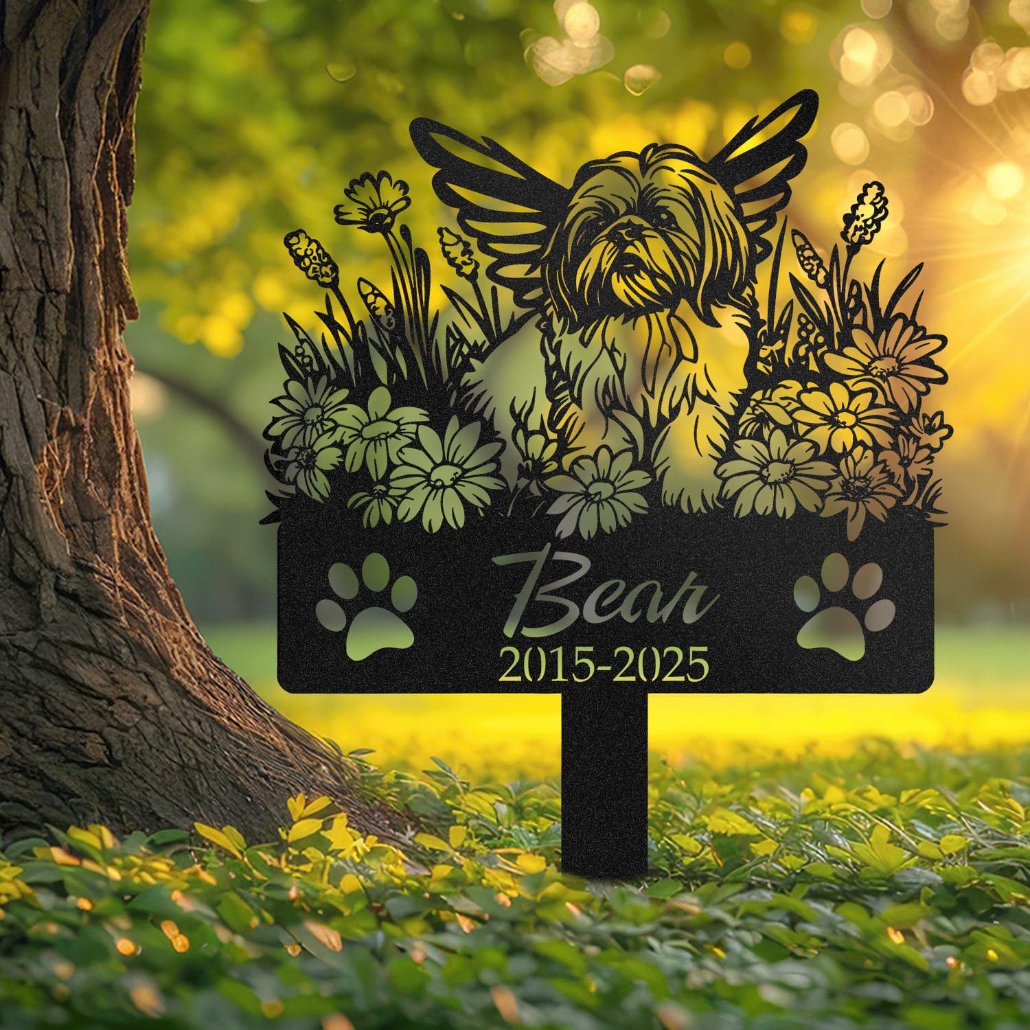 Shih Tzu pet grave marker displayed outdoors in a garden setting, showing the personalized angel wings and daisy floral design in place on the stake.