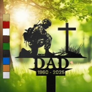 Metal memorial design of a soldier kneeling beside a battlefield cross marked by a helmet and boots, engraved with 'DAD' and personalized with memorial years.