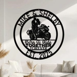 Metal wall art design of a couple riding together on a sport motorcycle, set within a circular frame reading the couple's names at the top and 'Born To Ride Together Forever' with the established year at the bottom, fully personalizable.