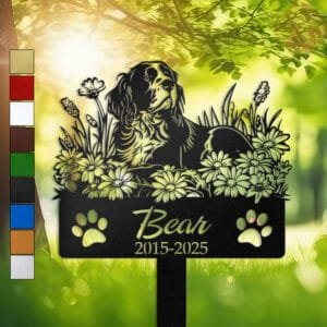Springer Spaniel resting in a resting sleeping pose within a daisy floral border on a personalized metal garden stake, with paw print cutouts at the base.