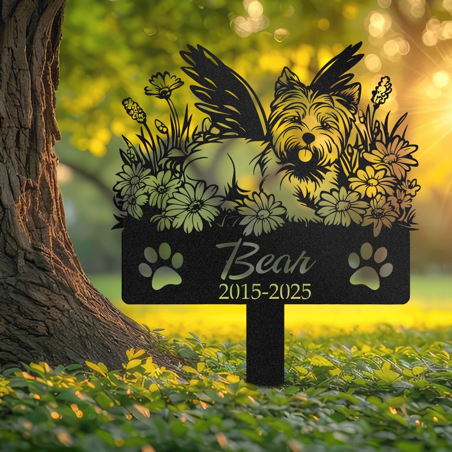 West Highland White Terrier pet grave marker displayed outdoors in a garden setting, showing the personalized angel wings and daisy floral design in place on the stake.