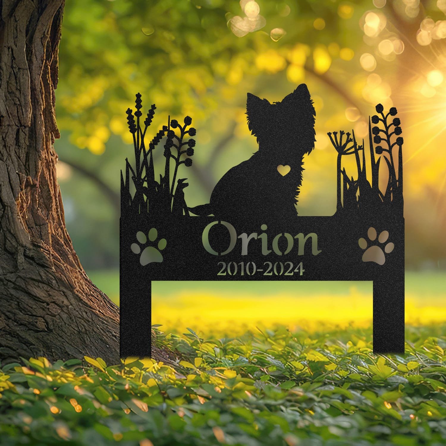 Yorkshire Terrier pet grave marker displayed outdoors in a garden setting, showing the personalized heart-cutout silhouette design in place on the stake.