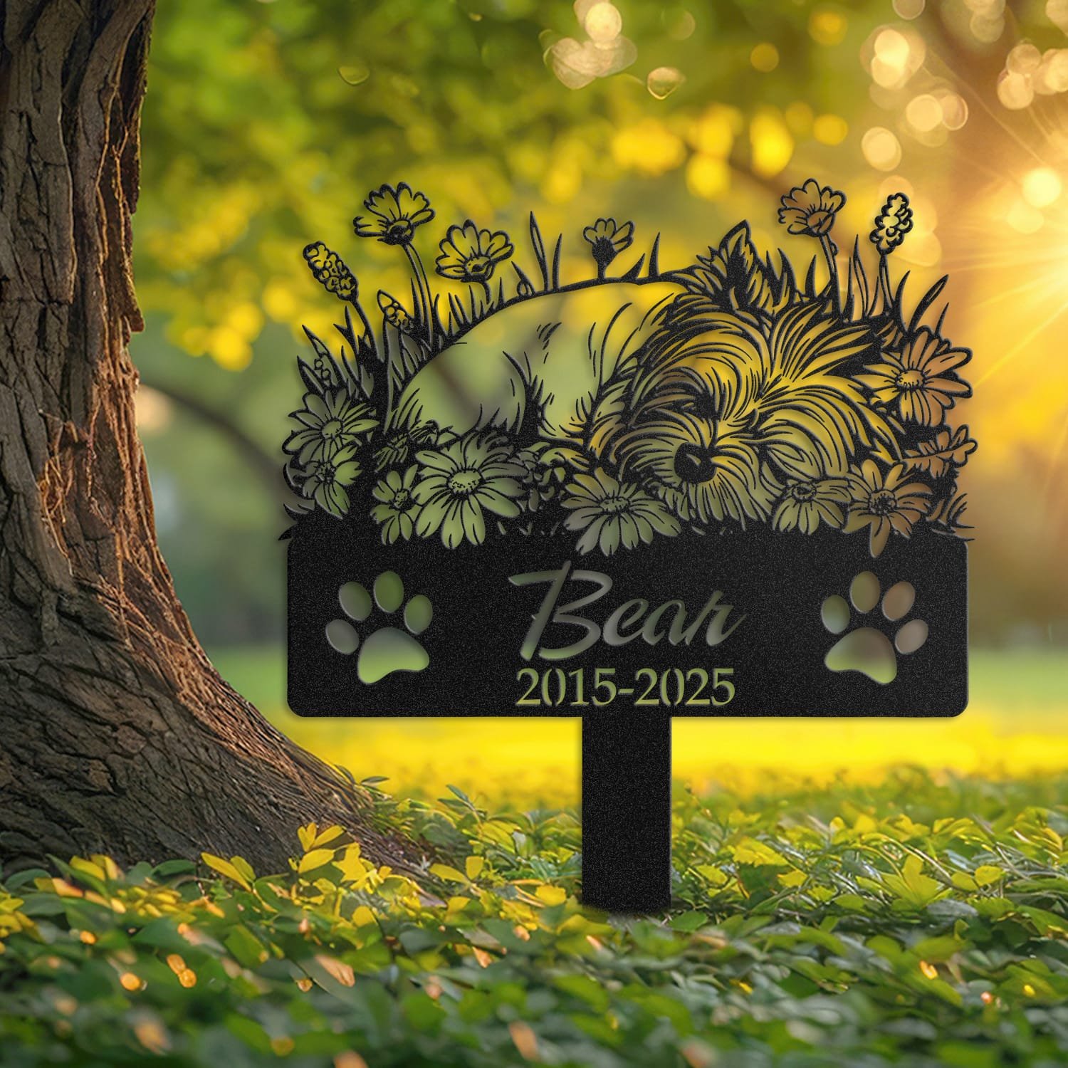 Yorkshire Terrier pet grave marker displayed outdoors in a garden setting, showing the personalized sleeping-pose daisy floral design in place on the stake.