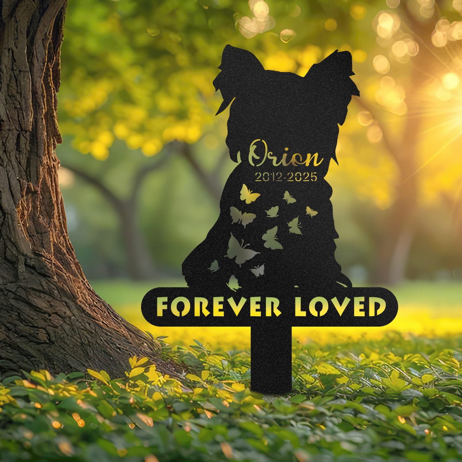Yorkshire Terrier pet grave marker displayed outdoors in a garden setting, showing the personalized two-pet silhouette design with the 'Forever Loved' engraving in place on the stake.
