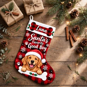 personalized buffalo plaid bone dog stocking shown laid flat on a wooden surface beside wrapped gifts and greenery